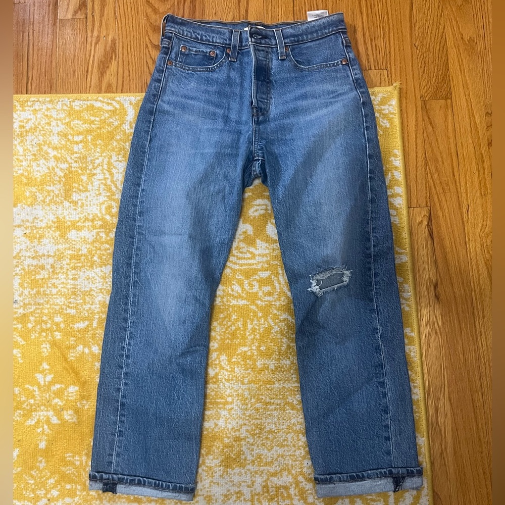 Levi high waisted darker blue Jean - rip in 1 knee